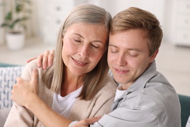 Photo of Happy son and his mother at home. Family bonding