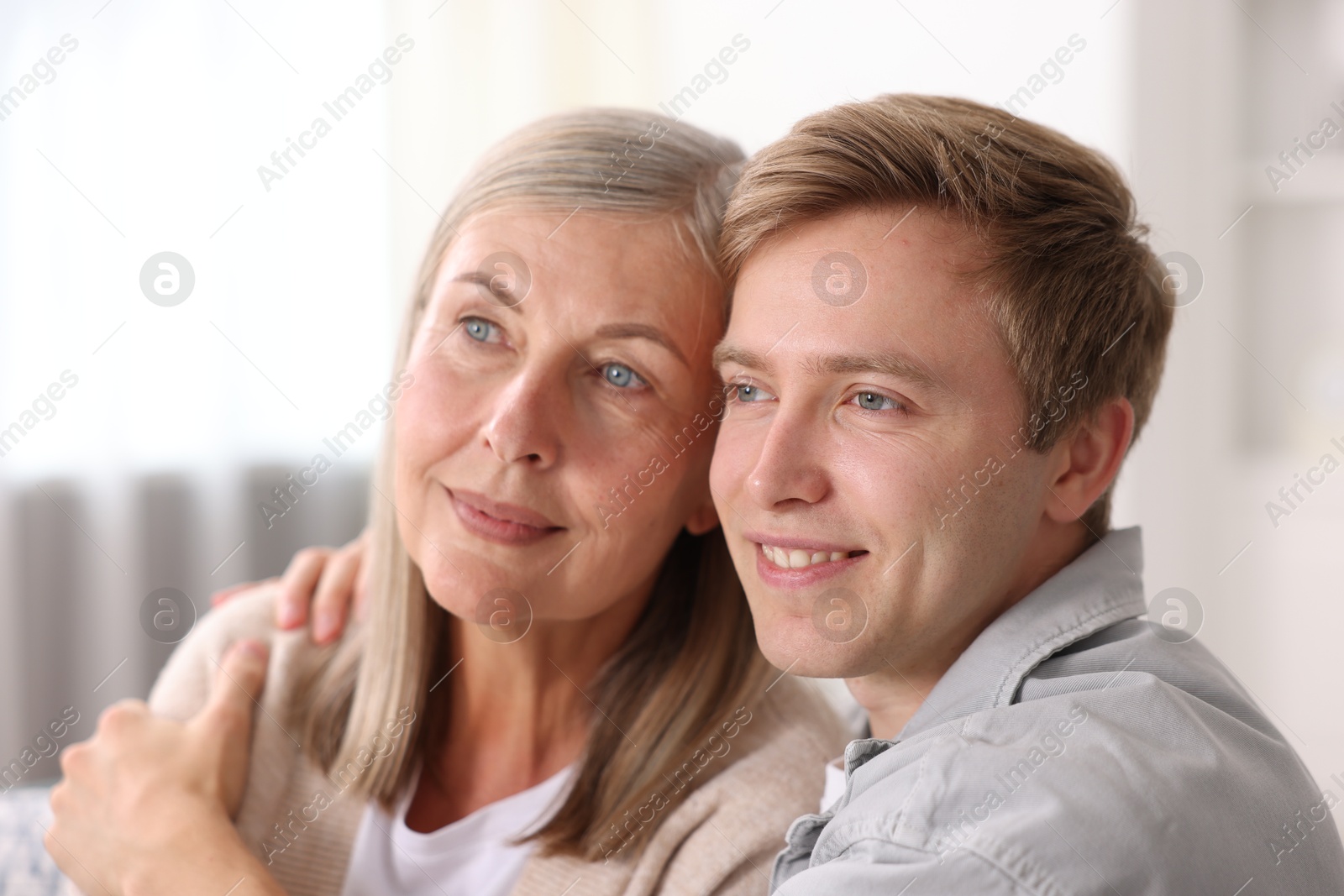 Photo of Happy son and his mother at home. Family bonding