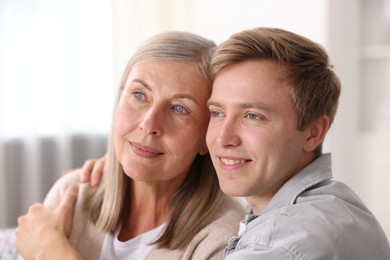 Photo of Happy son and his mother at home. Family bonding