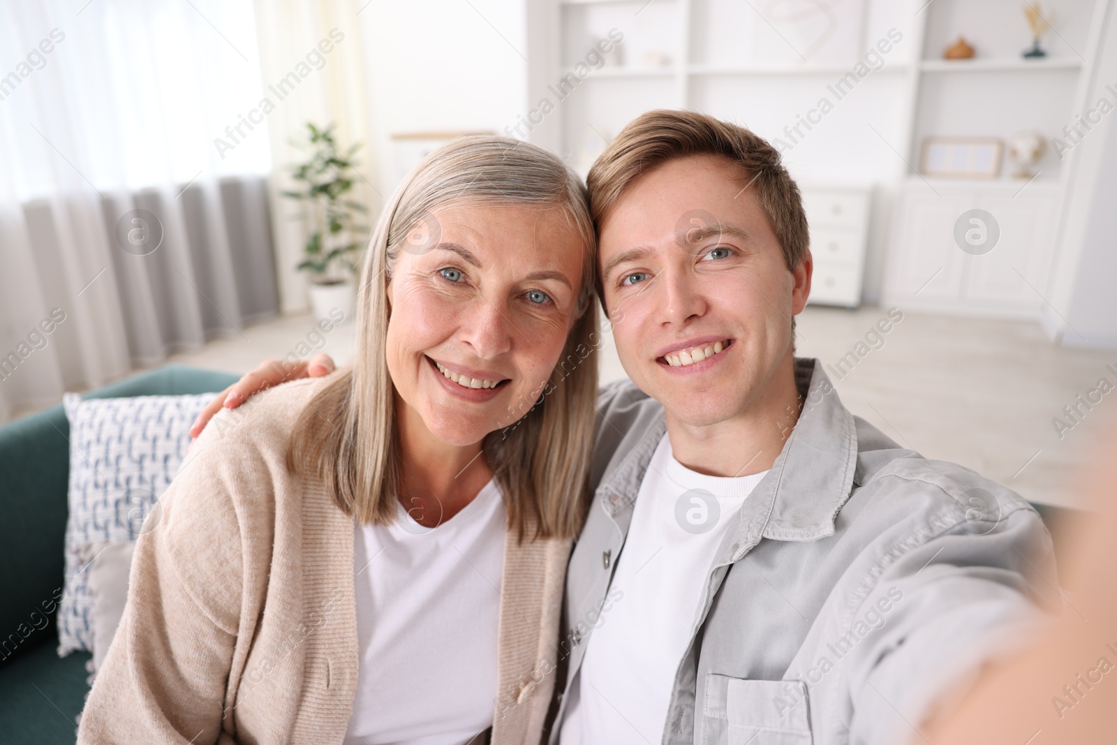 Happy son and his mother taking selfie at home Photo of Happy son and his mother taking selfie at home