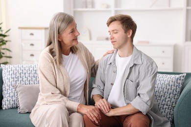 Photo of Happy mother and her son on sofa at home