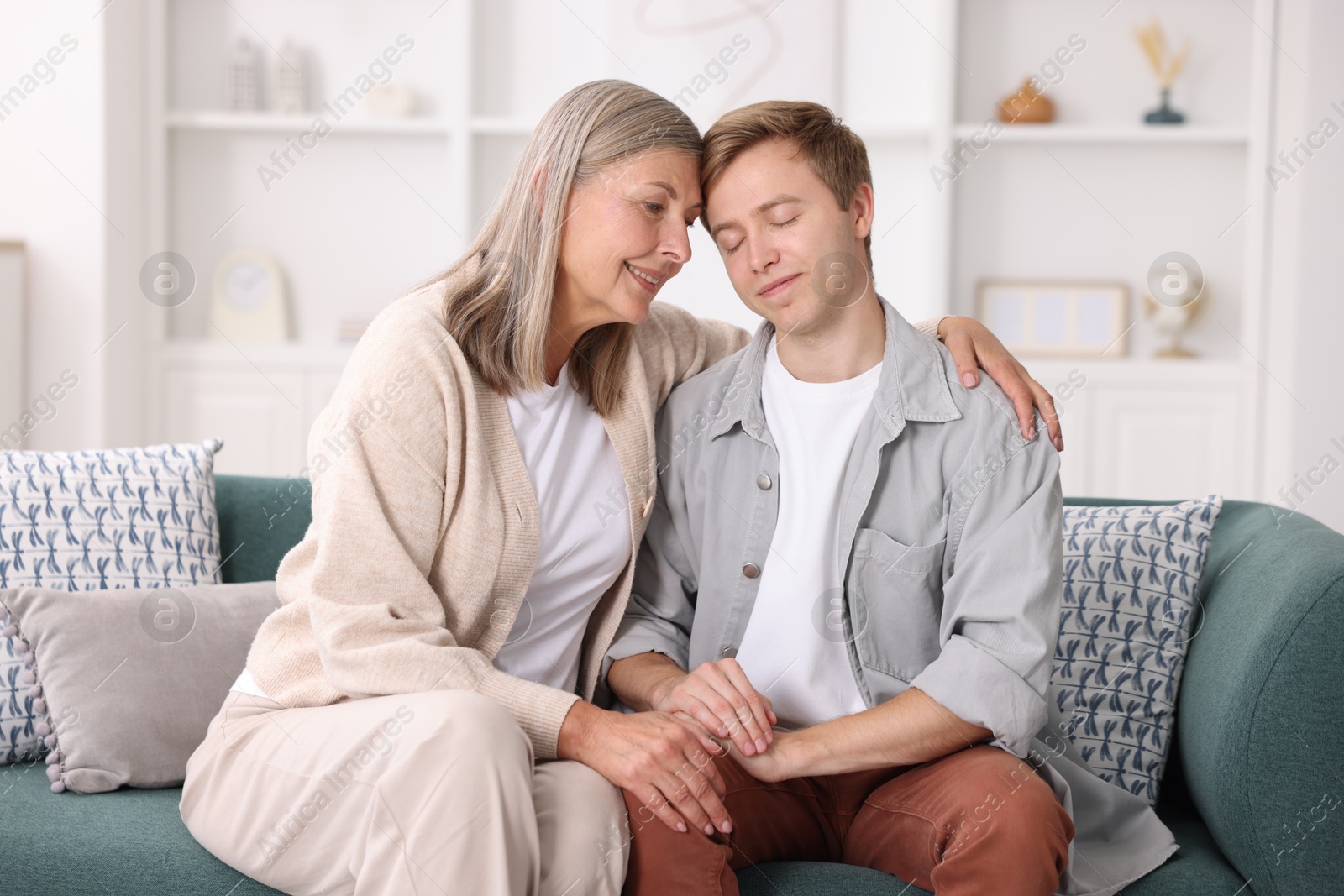 Photo of Happy mother and her son on sofa at home