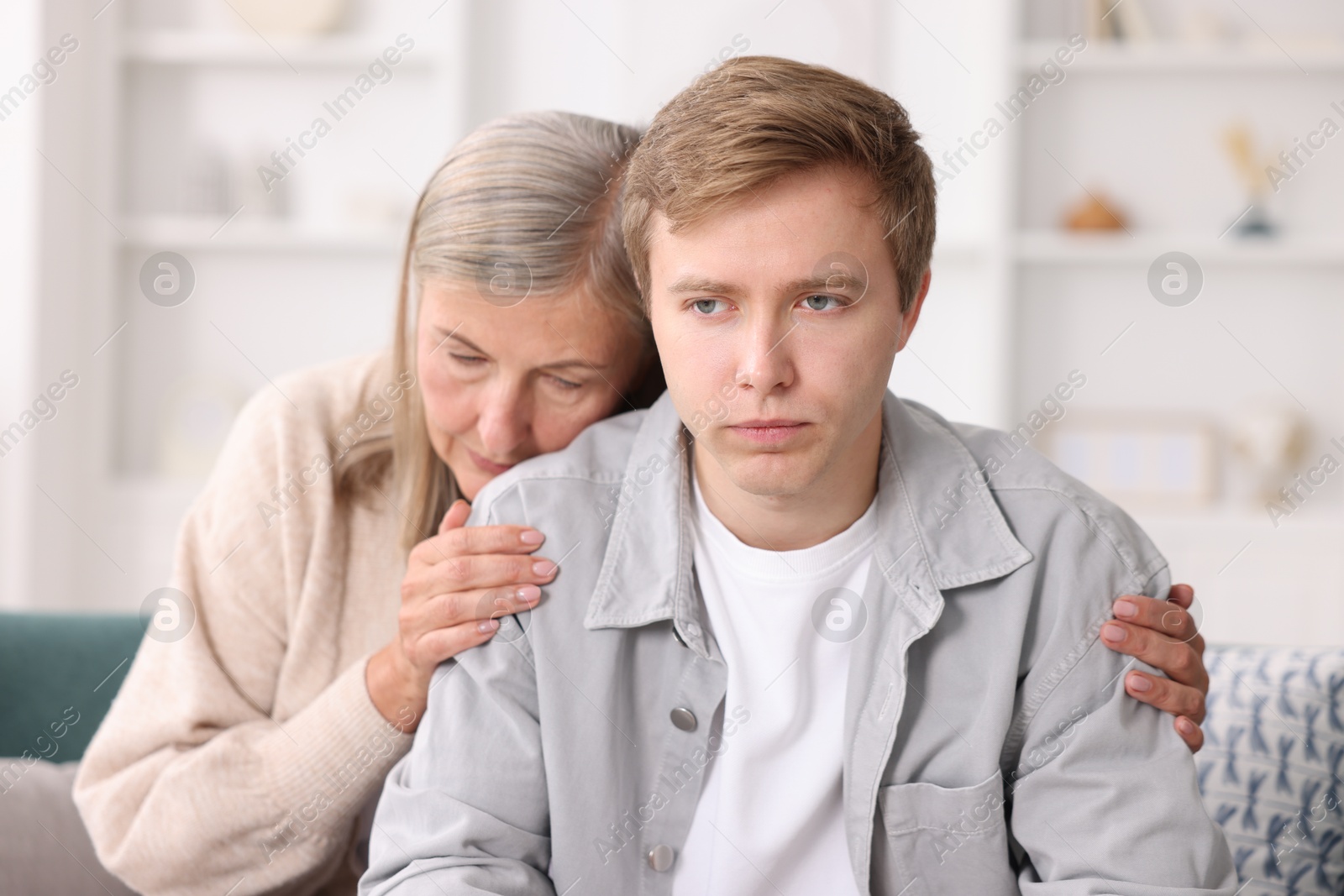 Photo of Mother supporting her son at home. Family bonding