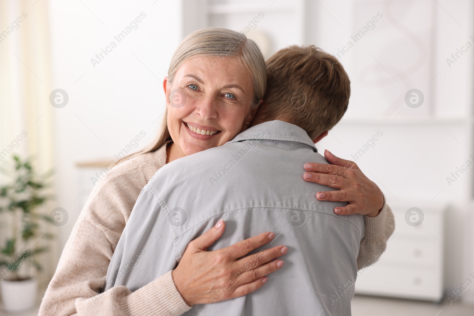Photo of Happy mother hugging her son at home