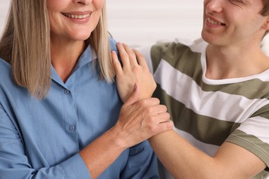Photo of Happy son and his mother indoors, closeup