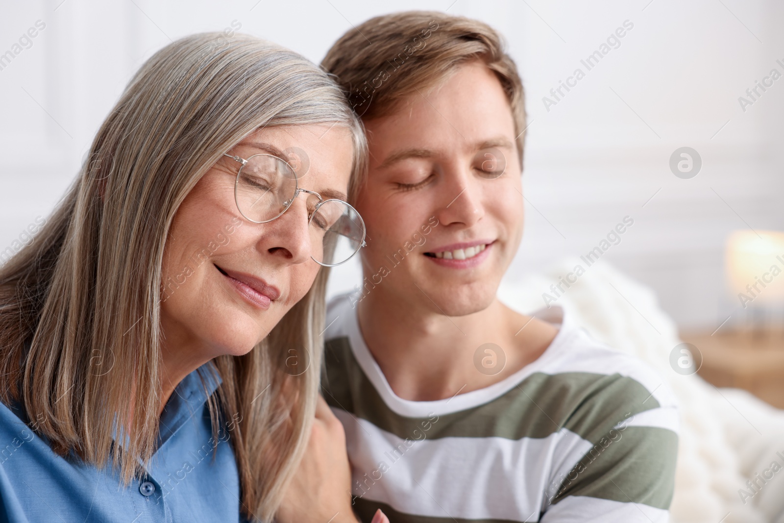 Photo of Happy son and his mother at home. Family bonding