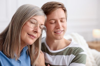 Photo of Happy son and his mother at home. Family bonding