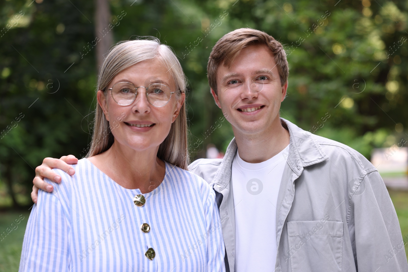 Photo of Family portrait of happy mother and her son outdoors