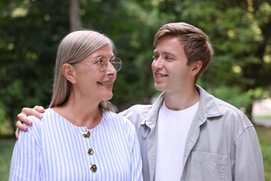 Photo of Happy mother and her son outdoors. Family bonding