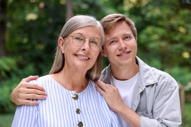 Photo of Family portrait of happy mother and her son outdoors