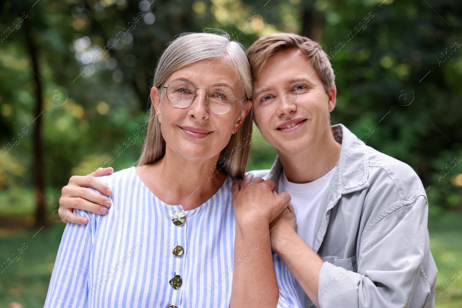 Photo of Family portrait of mother and her son outdoors