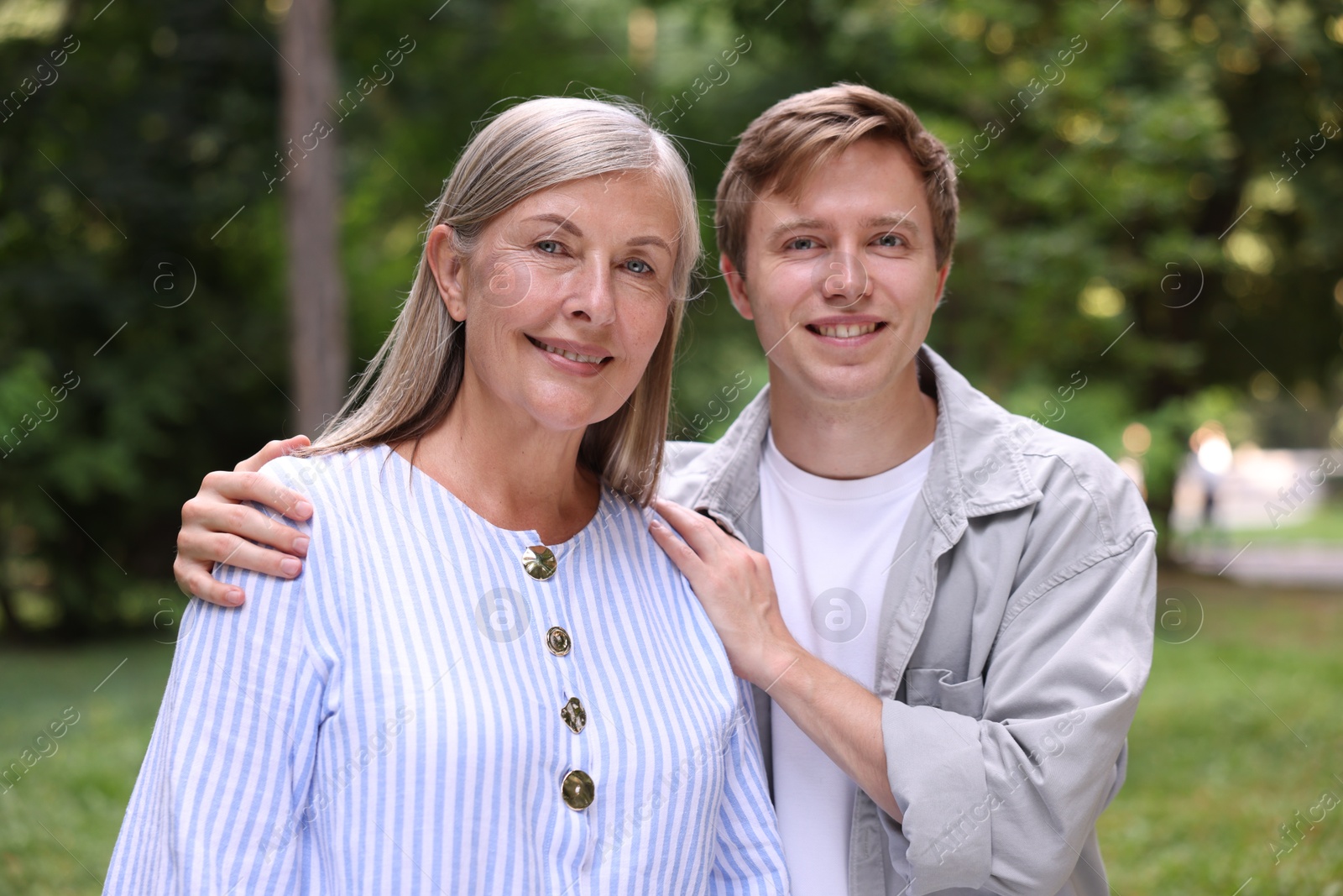 Photo of Family portrait of happy mother and her son outdoors