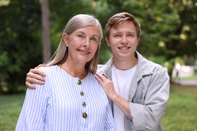 Photo of Family portrait of happy mother and her son outdoors