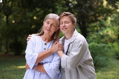 Photo of Mother and her happy son outdoors. Family bonding