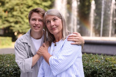 Photo of Mother and her son outdoors, space for text. Family bonding