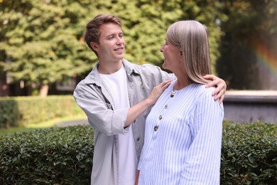 Photo of Mother and her son outdoors. Family bonding