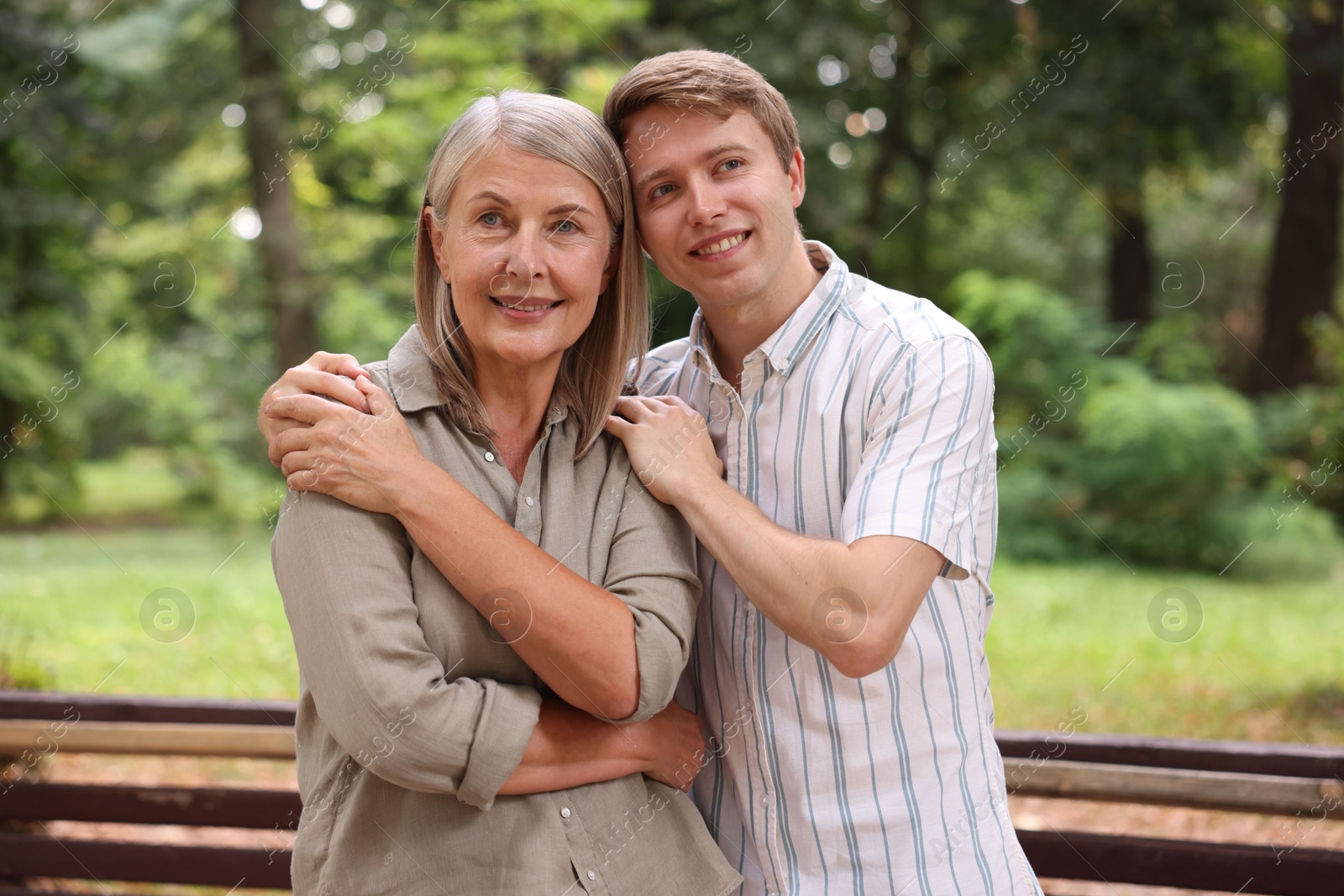 Photo of Smiling mother and her son in park. Family bonding