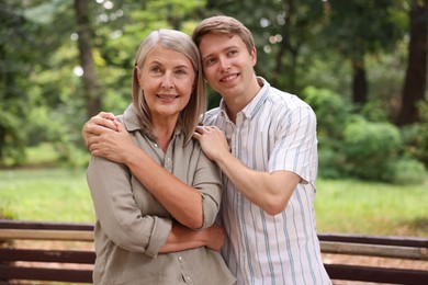 Photo of Smiling mother and her son in park. Family bonding