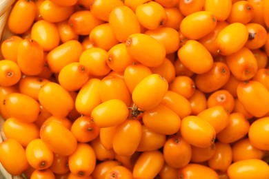 Photo of Fresh sea buckthorn berries as background, top view