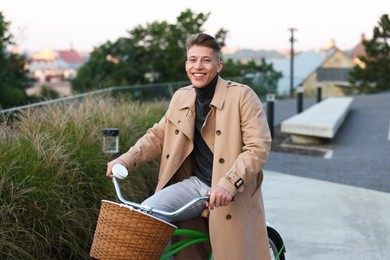 Photo of Happy man riding bicycle on city street