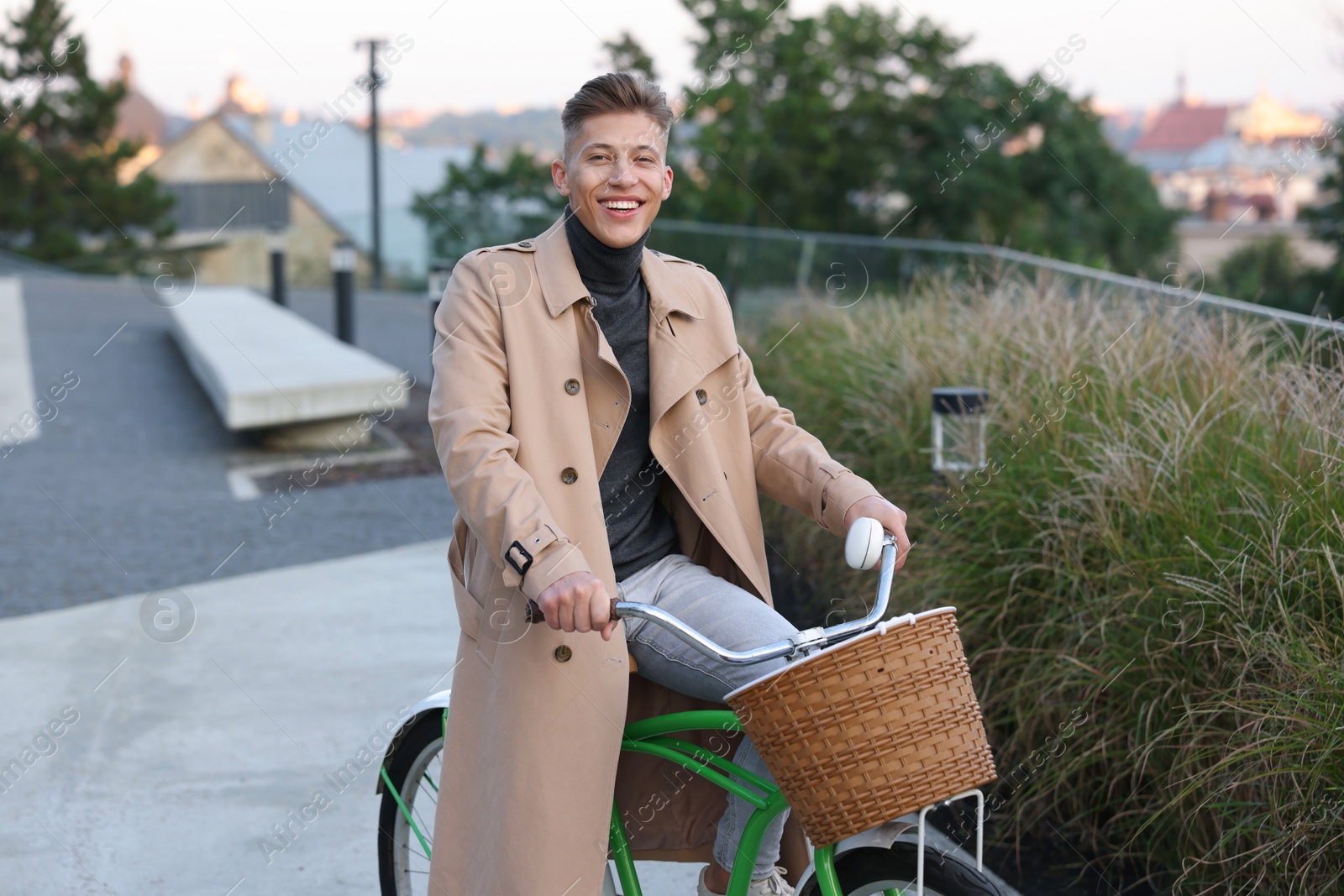 Photo of Happy man riding bicycle on city street