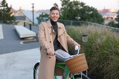 Photo of Happy man riding bicycle on city street