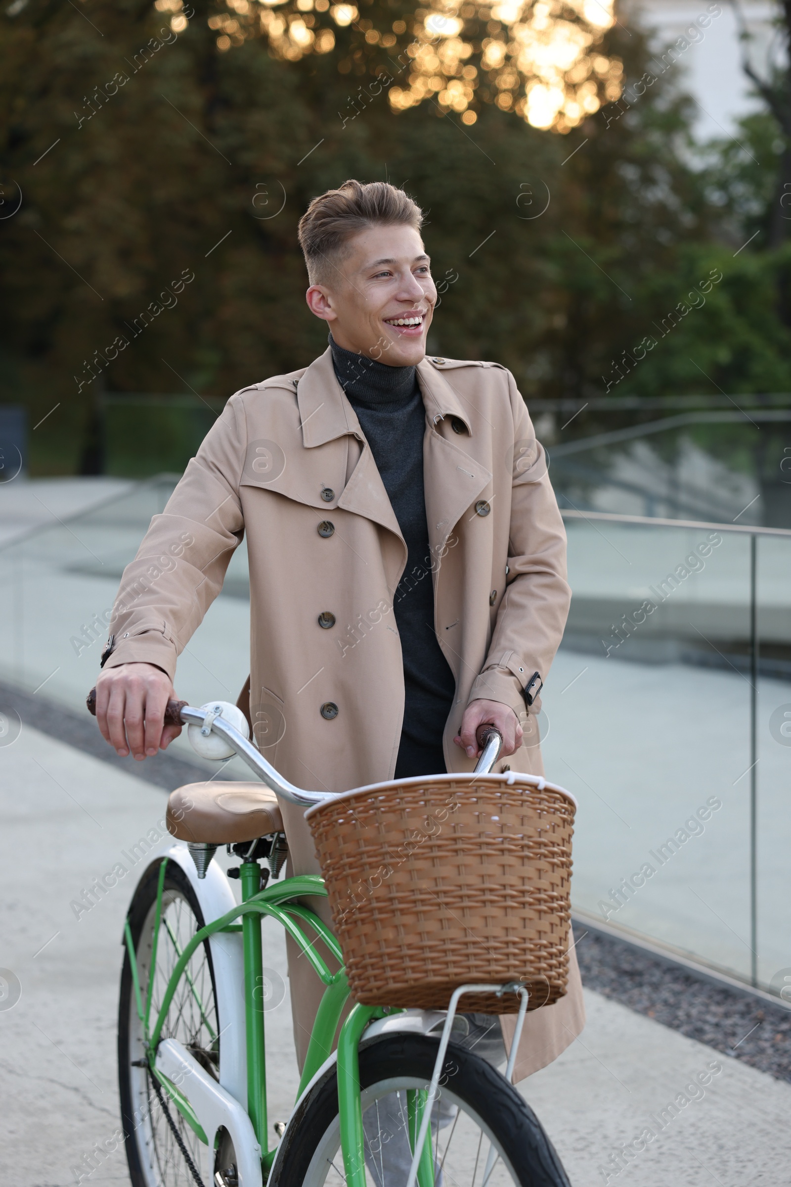 Photo of Happy man walking his bicycle on city street