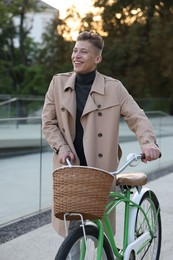 Photo of Happy man walking his bicycle on city street