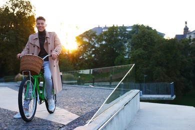 Photo of Happy man riding bicycle on city street. Space for text