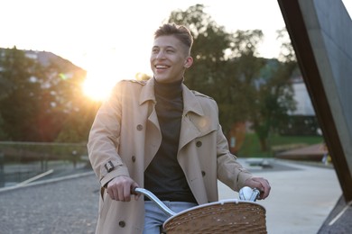 Photo of Happy man riding bicycle on city street
