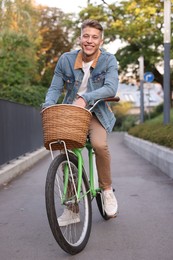 Photo of Happy man riding bicycle on city street