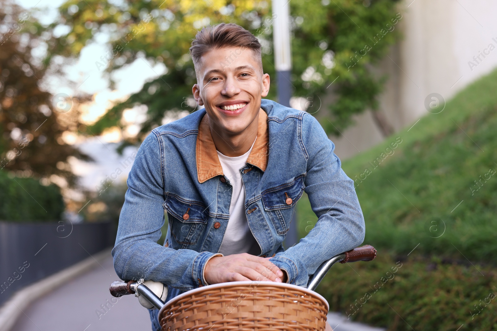 Photo of Happy man riding bicycle on city street