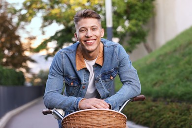 Photo of Happy man riding bicycle on city street