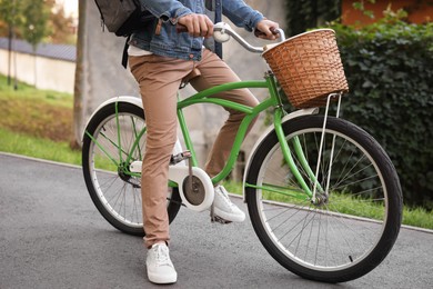 Photo of Man riding bicycle on city street, closeup