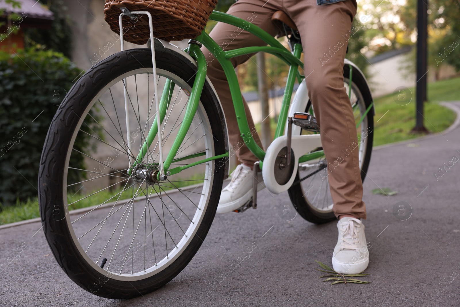 Photo of Man riding bicycle on city street, closeup