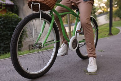 Photo of Man riding bicycle on city street, closeup