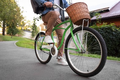 Photo of Man riding bicycle on city street, closeup