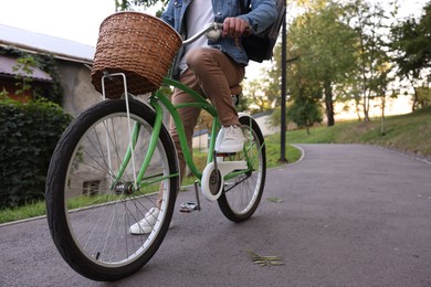 Photo of Man riding bicycle on city street, closeup