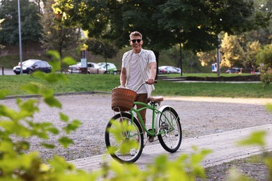 Photo of Happy man walking his bicycle on city street