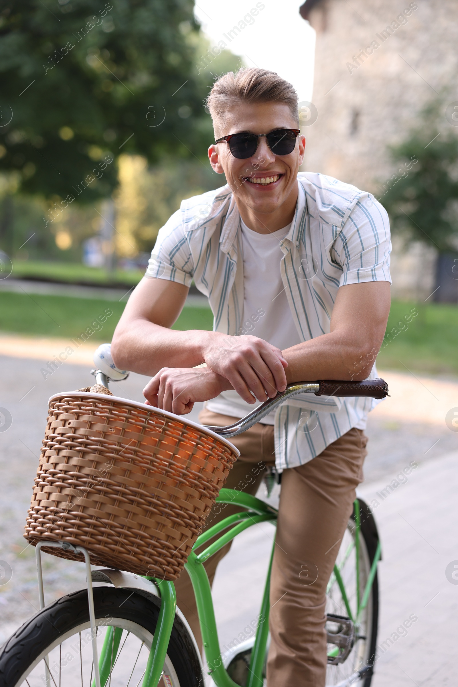 Photo of Happy man riding bicycle on city street
