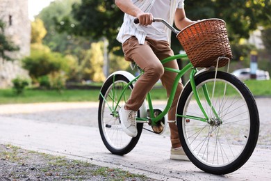 Photo of Man riding bicycle on city street, closeup