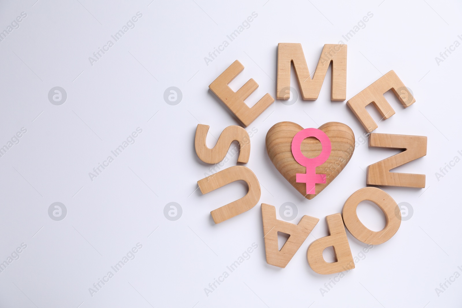 Photo of Word Menopause, female gender symbol and wooden heart on white background, top view. Space for text