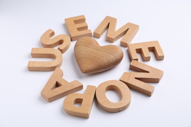 Photo of Word Menopause and wooden heart on white background, closeup