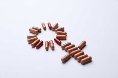 Photo of Menopause. Female gender symbol made with pills on light background, closeup