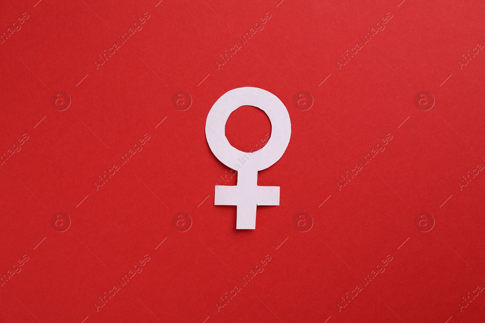 Menopause. Female gender symbol on red background, top view Photo of Menopause. Female gender symbol on red background, top view