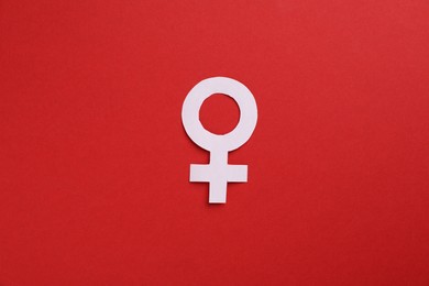 Photo of Menopause. Female gender symbol on red background, top view