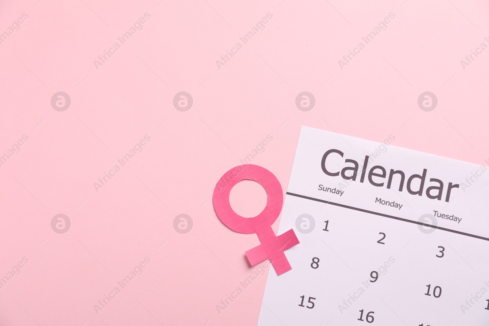 Menopause. Female gender symbol and calendar on pink background, top view. Space for text Photo of Menopause. Female gender symbol and calendar on pink background, top view. Space for text