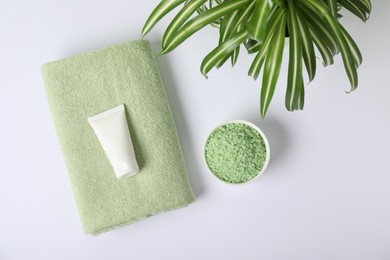 Photo of Fresh terry towel, cosmetic products and plant on white background, flat lay