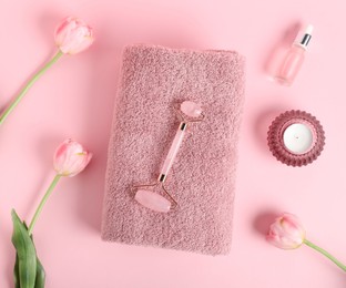 Photo of Fresh terry towel, candle, cosmetic products and tulip flowers on pink background, flat lay