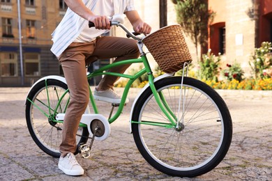 Photo of Man riding bicycle on city street, closeup